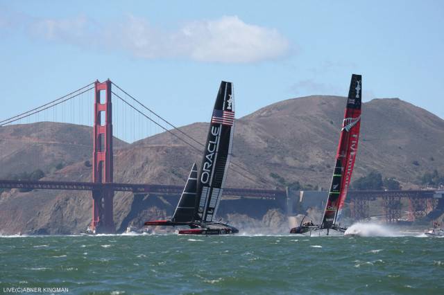 Oracle Team USA overtaking Team New Zealand by the Golden  Gate Bridge at the final match.