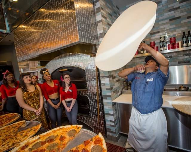 Pizza tosser Jorge Torres impresses the Pin-Up Pizza girls with his dough tossing skills. Photos: Erik Kabik