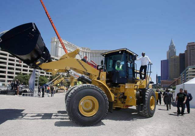 WBC welterweight champion Floyd Mayeather Jr. arrives on a bull dozer during a groundbreaking for a $375 million, 20,000-seat sports and entertainment arena being built by MGM Resorts International and AEG. The arena is scheduled to open in early 2016. Photos: Isaac Brekken/Getty Images