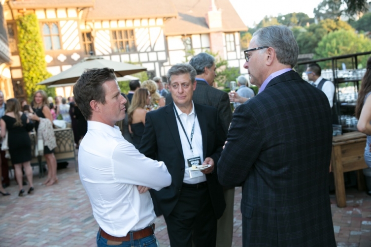Billy Bush talks with Richard Baer (center) with guest