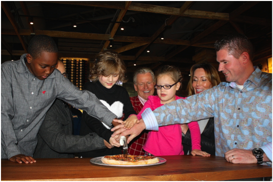 CPK CEO G.J. Hart and General Manager, Clay Wilson are surrounded with loveable Make-A-Wish kids as they slice the ceremonial first pizza and welcome CPK to Downtown Summerlin. 