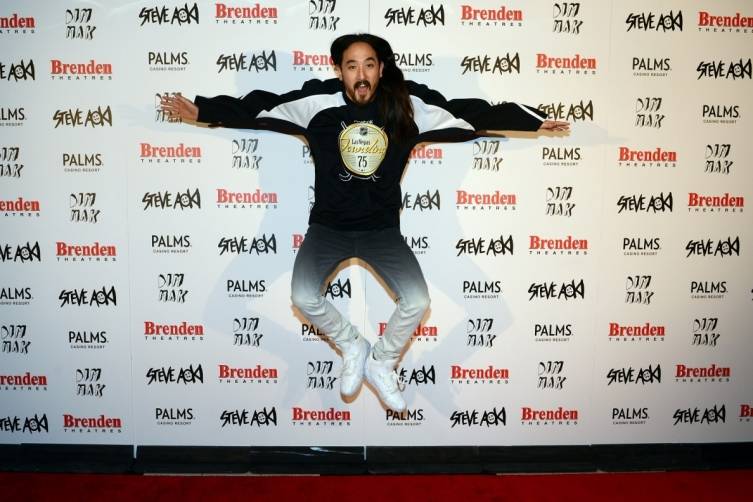 Steve Aoki jumps up in the air with excitement while being presented with Brenden celebrity star at the Palms. 