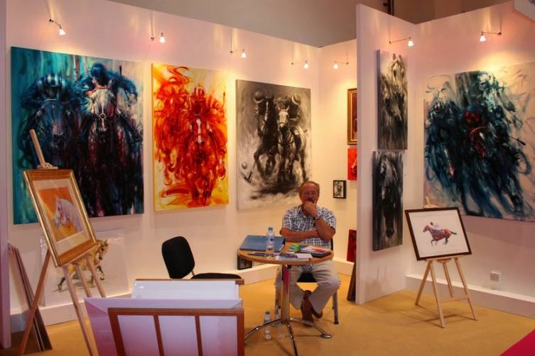 An artist and his creations at the World Art Dubai Event. 