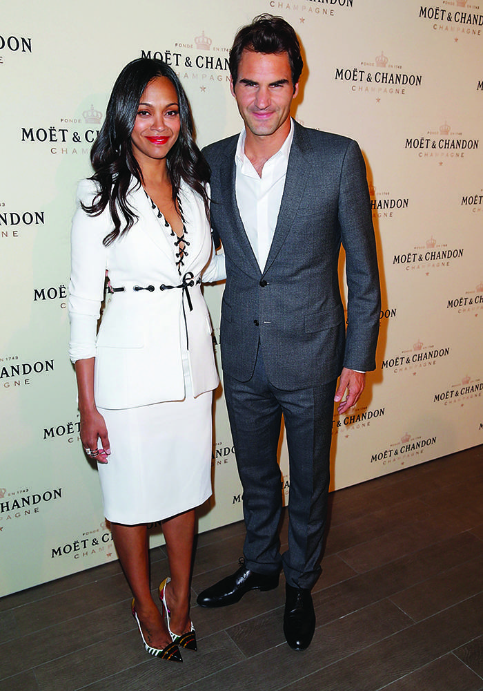 LOS ANGELES, CA - MARCH 07:  Actress Zoe Saldana (L) and tennis player Roger Federer attend the Moet & Chandon toast to honor brand ambassador Roger Federer's history-making 1,000th career win at Four Seasons Hotel Los Angeles at Beverly Hills on March 7, 2015 in Los Angeles, California.  (Photo by Joe Scarnici/Getty Images for Moet & Chandon)