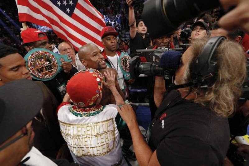 Floyd Mayweather is surrounded by fans after winning his 49th undefeated bout 