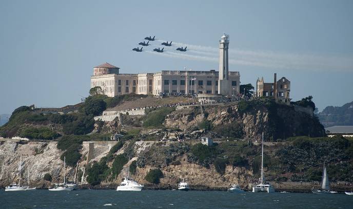 The U.S. Navy flight demonstration squadron, the Blue Angels, fly over Alcatraz Island during a performance for San Francisco Fleet Week 2011.