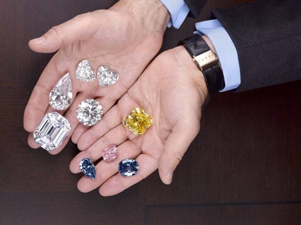 Laurence Graff holds a selection of the world's most valuable gemstones
