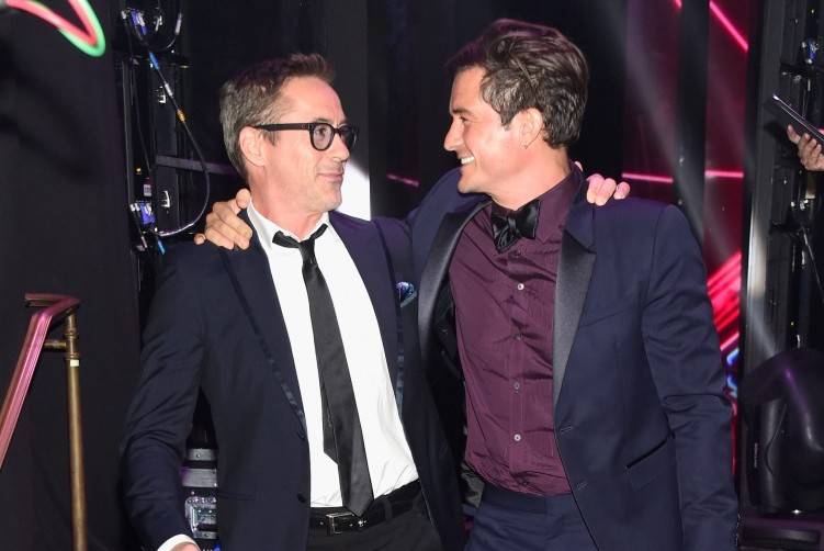 Robert Downey Jr. (L) and honoree Orlando Bloom (holding the the Britannia Humanitarian Award presented by The Beazley Group) attend the 2015 Jaguar Land Rover British Academy Britannia Awards 