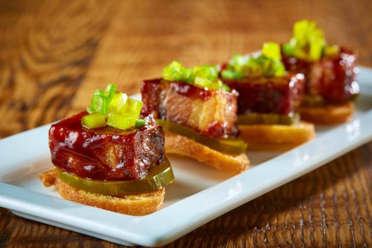 The pork belly appetizer is glazed with an ancho barbecue sauce.