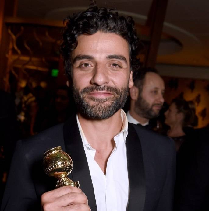 Oscar Isaac poses with his award for Best Actor at HBO's Official Golden Globe Awards After Party at The Beverly Hilton Hotel on January 10 
