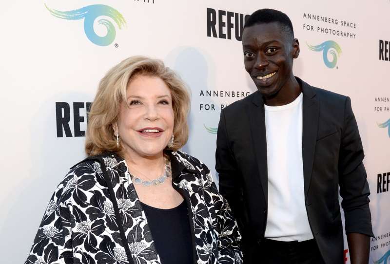 President and Chairman of the Board of The Annenberg Foundation, Wallis Annenberg (L) and featured artist Omar Victor Diop attend the opening of REFUGEE Exhibit at Annenberg Space For Photography 