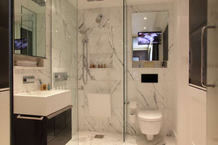 the-italian-marbled-bathrooms-are-kitted-with-underfloor-heating-and-a-flatscreen-tv-embedded-in-the-mirrors
