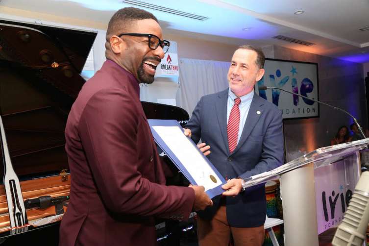 Mayor Phillip Levine presenting DJ IRIE with a proclamation at the #InspIRIE Gala dinner