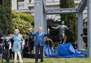 Bennett stands in front of his statue