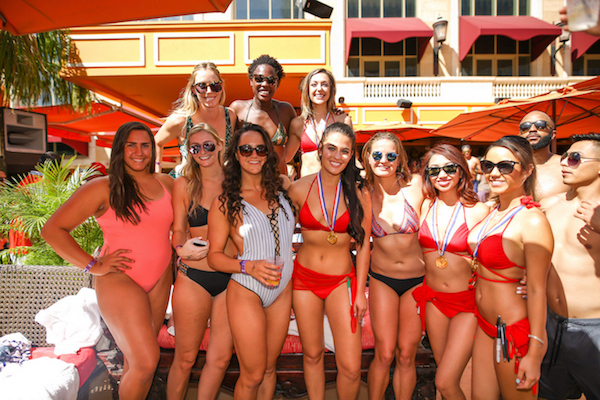 The U.S. Olympic Women’s Water Polo Team celebrates their gold medals at Tao Beach. 