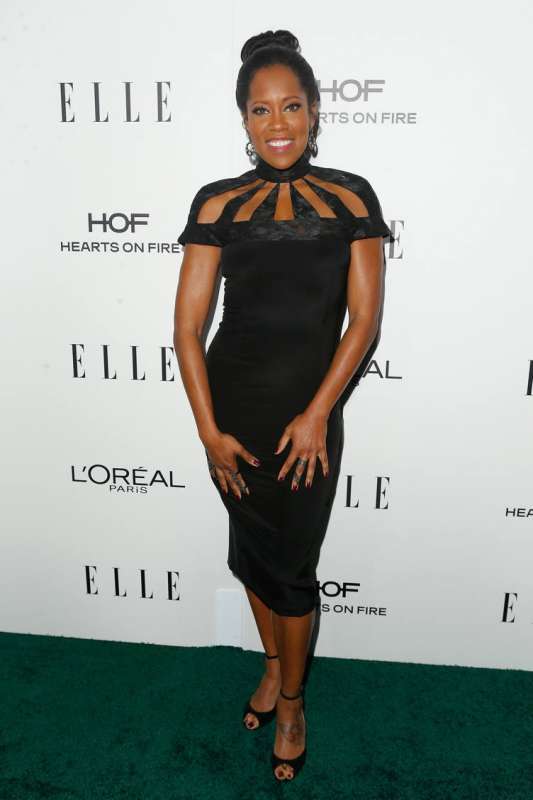 Regina King is wearing a Regina is wearing a Christian Siriano dress. 