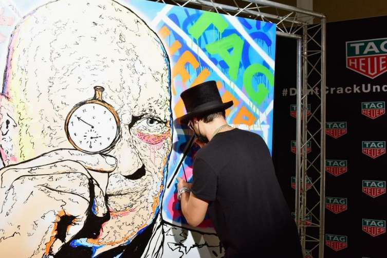 TAG Heuer's Art Provocateur Alec Monopoly spray-paints a liking of the brand's CEO Jean-Claude Biver.