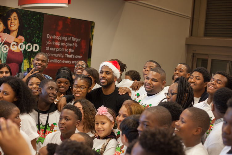 Chris Paul dons a Santa hat while helping kids shop at the 3rd Annual Holiday Takeover 