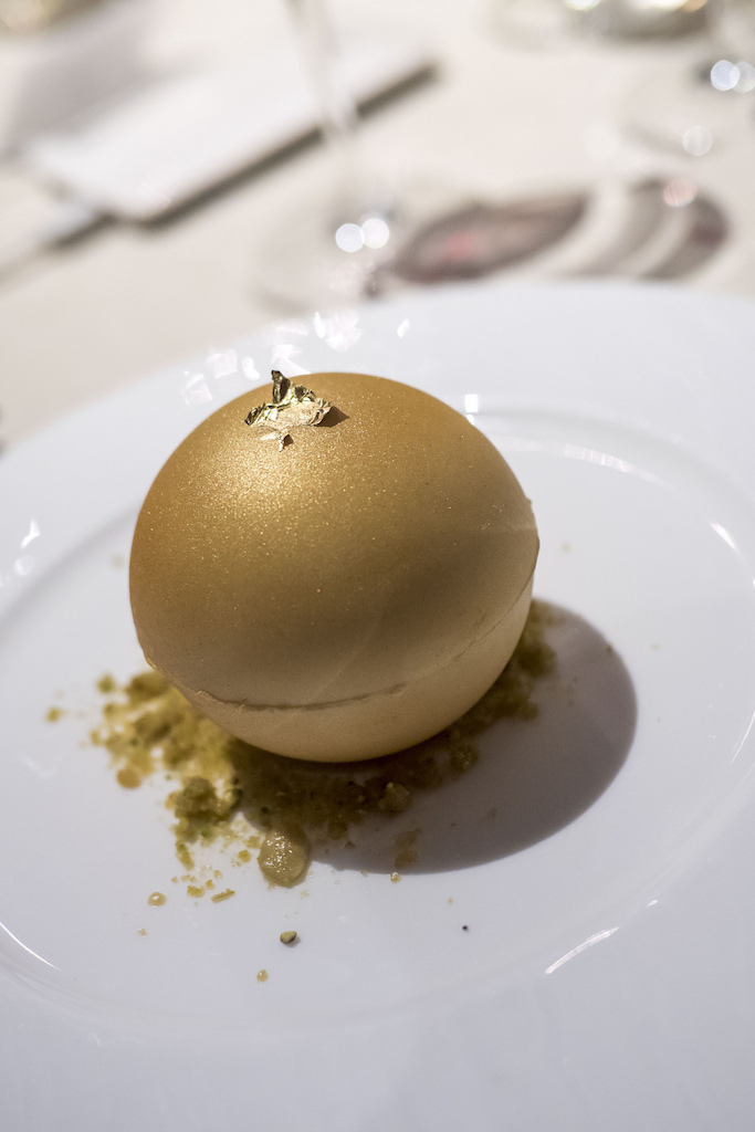 Dessert: a gold sphere with white chocolate and apple butterscotch