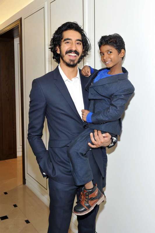 Actors Dev Patel (L) and Sunny Pawar wearing Burberry