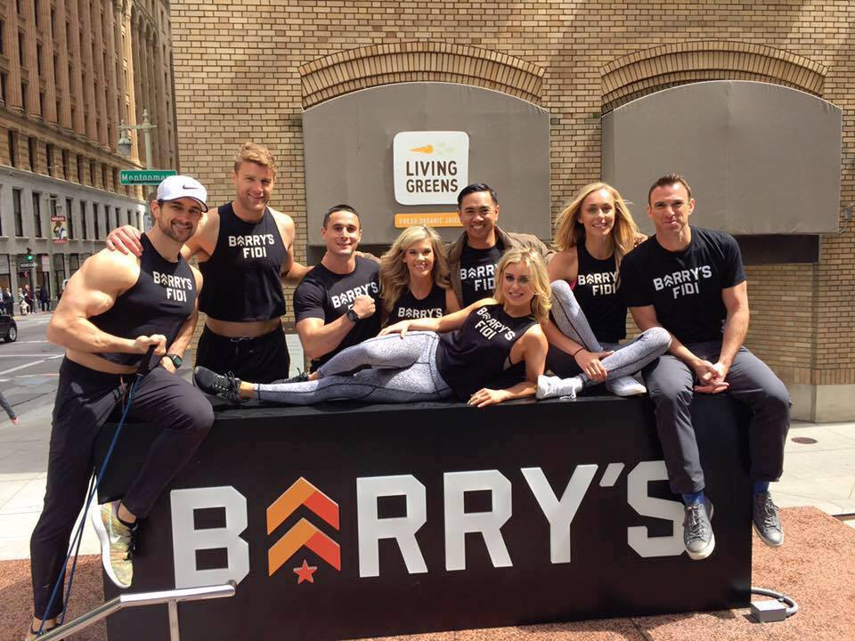 Trainers at Barry's Bootcamp pose beside the new Bush Street sign