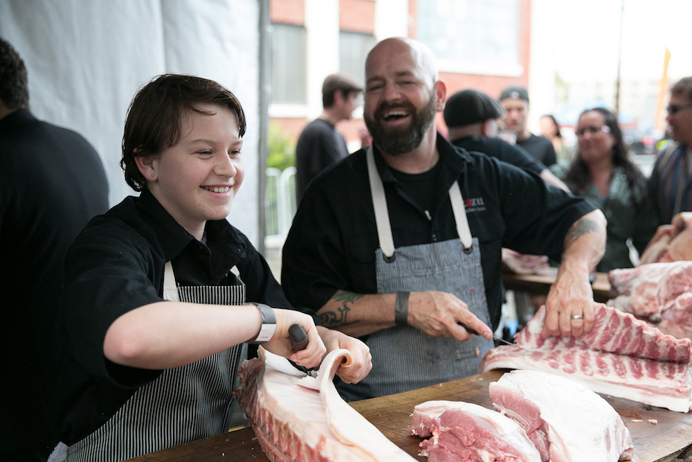 Chefs break down a whole pig during last year's event