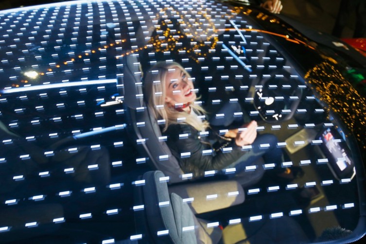 Julianne Hough tries out the Volkswagen electric concept vehicle.