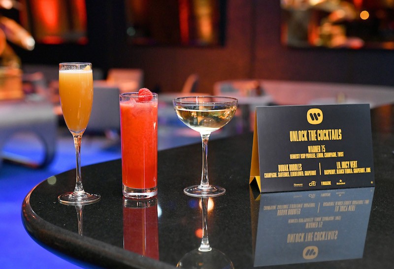 Beverages and a cocktail menu are displayed during the Warner Music Group Pre-Grammy Party in association with V Magazine.