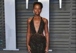 Lupita Nyong'o attends the 2018 Vanity Fair Oscar Party at Wallis Annenberg Center for the Performing Arts wearing Armani Prive and Forevermark Diamonds