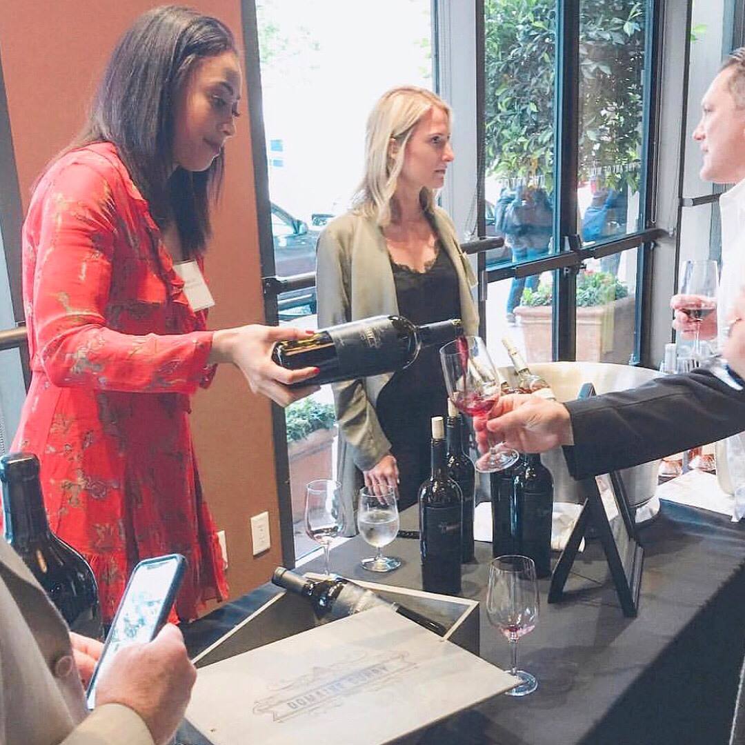 Sydel Curry, left, pouring her wine at the recent reception