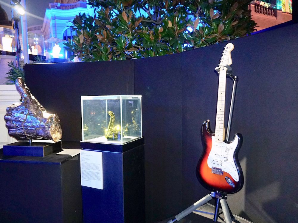 Auction items included Mick Jagger’s guitar and a sculpture by Jeff Koons