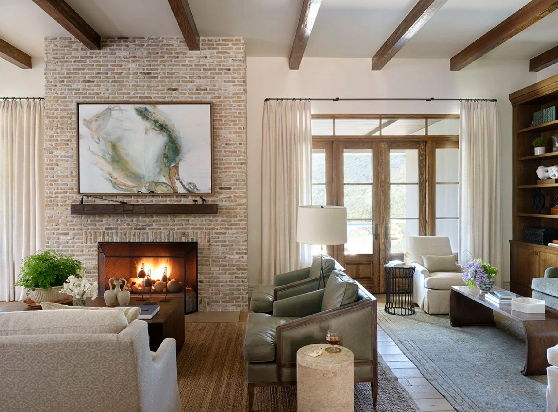 Living room with brick fireplace, exposed wood beams, and abstract art, Westlake Village / Lake Sherwood, California, by Tammy Randall Wood / Interior Archaeology