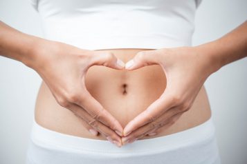 Close,Up,Of,Woman’s,Hands,Made,Heart,On,Belly,Isolated
