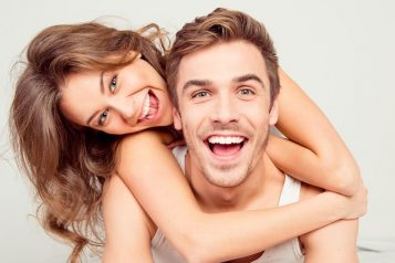 Cheerful,Smiling,Couple,In,Love,Hugging,In,The,Bedroom