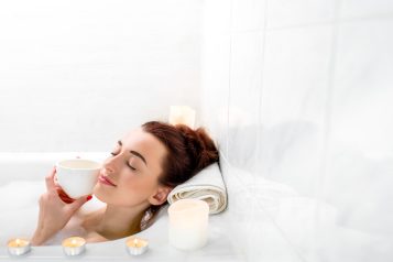 Young,Woman,Enjoying,Coffee,While,Lying,In,The,Bath,With