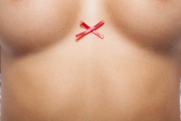 Woman,Breast,With,Little,Red,Bow.