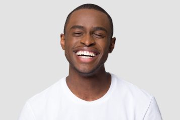 Cheerful,Happy,African,Millennial,Man,Laughing,Looking,At,Camera,Isolated