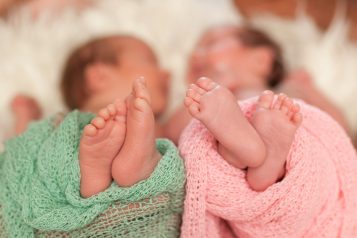 Twins,Baby,Feet,Wraped,With,Blanket