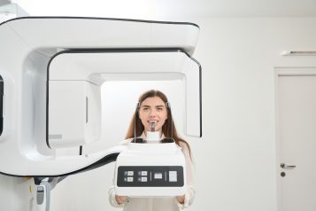 Female,Patient,Having,Her,Teeth,Scanned,With,Tomograph