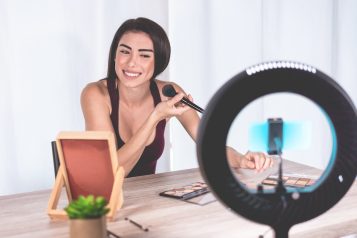 Young,Influencer,Woman,Creating,Social,Media,Videos,With,Smartphone,While