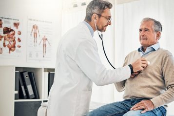 doctor checking patient heartbeat