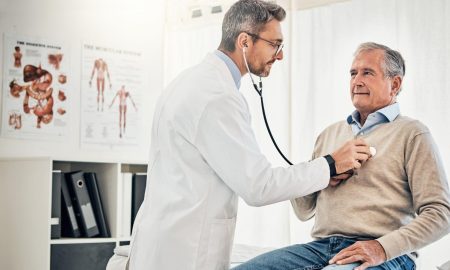 doctor checking patient heartbeat