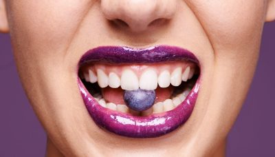closeup of women eating blueberry