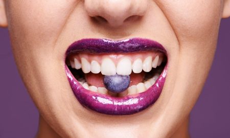 closeup of women eating blueberry