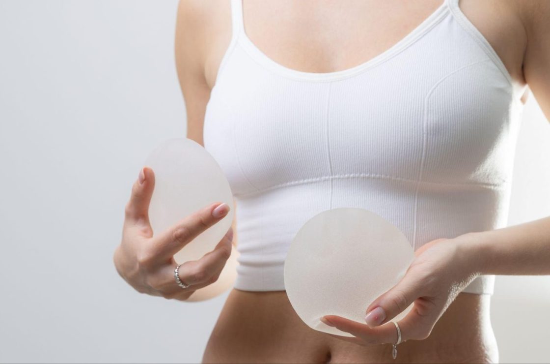 women holding breast implants