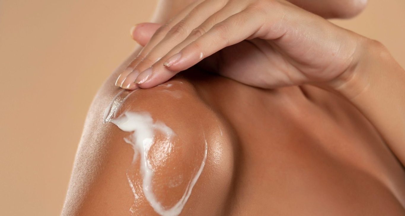 model applying cream on skin