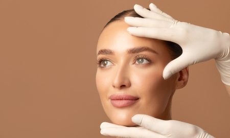 Doctor examining young woman's face, beautiful lady during visit to cosmetologist cabinet - cosmetics surgery trends 2026