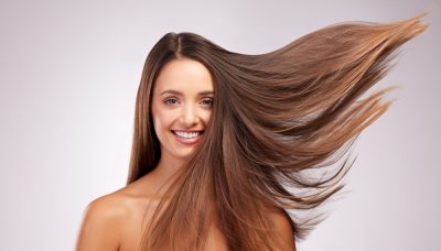 wind and portrait of woman with smile, hairstyle shine and luxury salon treatment