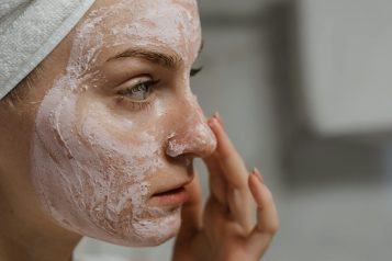 women applying skin cream