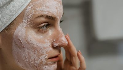 women applying skin cream